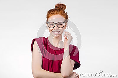 Portrait of attractive young redhead woman smiling with glasses Stock Photo