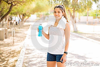Sportswoman with a water bottle at park Stock Photo