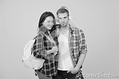 Portrait of attractive young students couple. cheerful woman wearing backpack. guy in headphones. online education Stock Photo