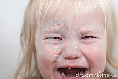 Portrait baby blonde hair emotion crying tears Stock Photo