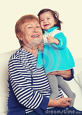 Portrait of baby girl and grandmother yellow toned Stock Photo