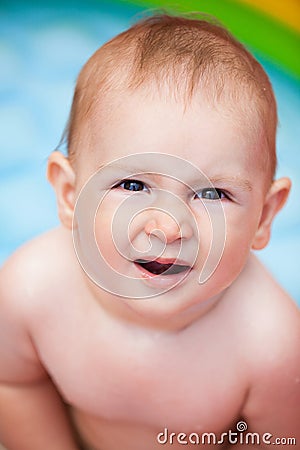 Portrait of a baby in a swimming pool in the summer Stock Photo