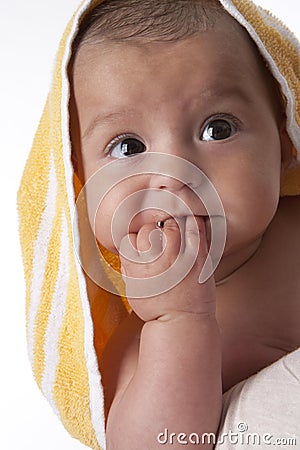 Portrait of a baby wrapped in a towel Stock Photo