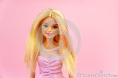 Portrait of a Barbie doll with loose blond hair on a pink background Editorial Stock Photo