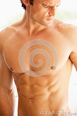 Portrait Of Bare Muscular Torso Of Young Man Stock Photo