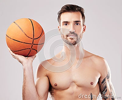 Portrait, basketball and man with fitness, sport and exercise with motivation on grey studio background. Face, male Stock Photo