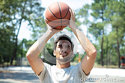 portrait basketball player taking jump shot Stock Photo