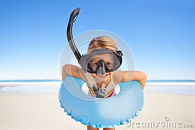 Portrait, beach and child with goggles and inflatable gear for swimming, summer holiday and happy outdoor adventure Stock Photo
