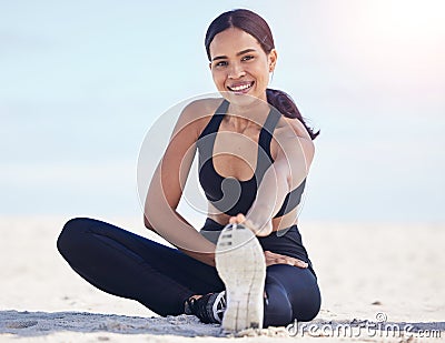 Portrait, beach and woman stretching feet happy in nature for running, workout or body, exercise or wellness. Shoes Stock Photo