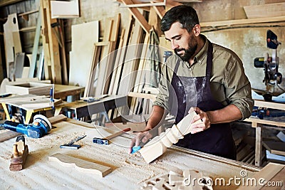 Bearded Carpenter Carving Stair Posts in Shop Stock Photo