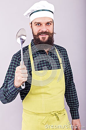 Portrait of a bearded chef holding a big spoon Stock Photo