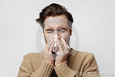 Portrait bearded ill man wearing jersey coughing standing empty background. Stock Photo