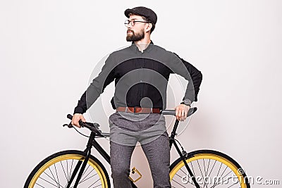 Portrait of a bearded man leaning on fixie bicycle over white background Stock Photo
