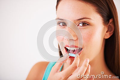 Starting the day with a vitamin capsule. Portrait of a beautfiul young woman about to take a tablet. Stock Photo