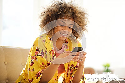 Beautiful african american woman using cellphone at home Stock Photo