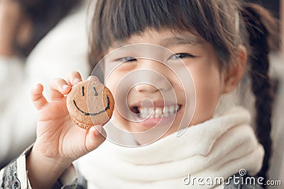 Portrait of beautiful asia Children feel happy eating Bread smiley face Stock Photo