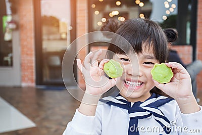 Portrait of beautiful asia Children feel happy eating two dessert tarts Stock Photo