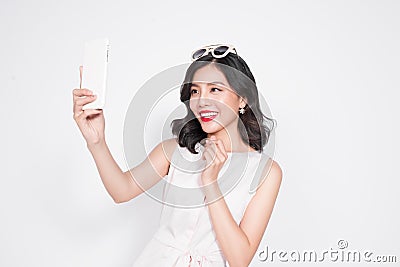 Portrait of beautiful asian fashionable girl taking selfie Stock Photo