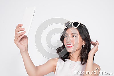 Portrait of beautiful asian fashionable girl taking selfie Stock Photo