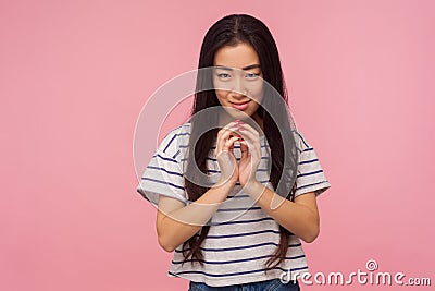 Portrait of beautiful asian girl with long brunette hair scheming evil idea and looking at camera with slyly expression Stock Photo