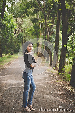 Portrait a beautiful asian woman at forest in the morning Stock Photo