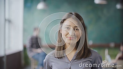 Portrait of beautiful Asian woman in modern office. Young successful businesswoman looking at camera, smiling. Stock Photo