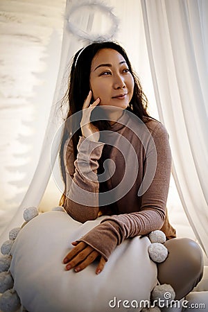 Portrait of beautiful asian woman with white angel nimbus on head Stock Photo