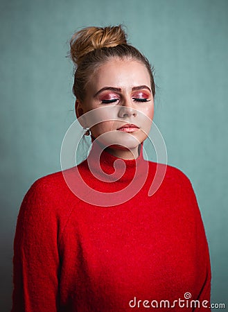 Portrait of beautiful blonde - face with beautiful closed eyes - isolated on cyan background. Young pretty girl female model Stock Photo