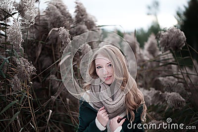 Portrait of a beautiful blonde girl with freckles inwarm sweater or jacket. Stock Photo