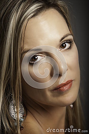 Portrait of beautiful blonde older woman with silver earring Stock Photo