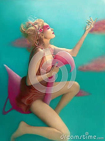 Portrait of beautiful blonde woman with pink flamingo Stock Photo