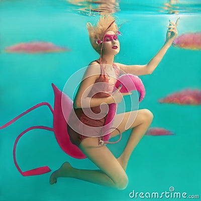Portrait of beautiful blonde woman with pink flamingo Stock Photo