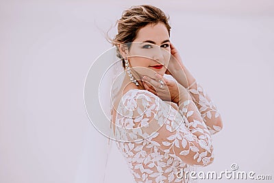 Portrait of a beautiful bride in the desert, blonde posing for a photographer on a wedding day Stock Photo