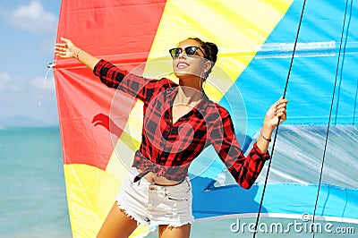 Portrait of beautiful brunette girl holds boat sails and smiling Stock Photo