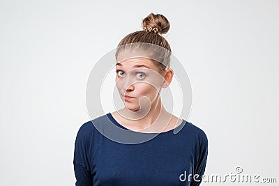 Portrait of a beautiful caucasian woman in blue shirt interested in something Stock Photo