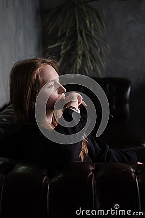 portrait of beautiful confident brunette woman in black in grey dark room. business woman. feminine. millennial people Stock Photo