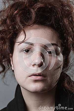 Portrait of a beautiful curly girl on a gray background Stock Photo