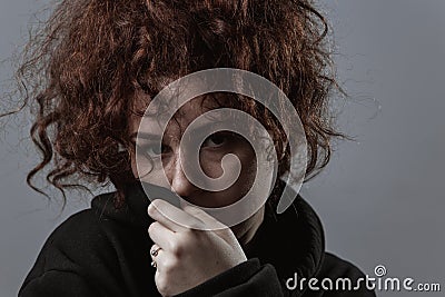 Portrait of a beautiful curly girl on a gray background Stock Photo