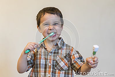 portrait of a beautiful cute caucasian blond boy with a toothbrush. Little boy brushing teeth and smiling while taking care of Stock Photo