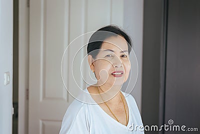 Portrait beautiful elderly asian woman in room,Senior female happy and smiling,Lifestyle concept,Positive thinking Stock Photo