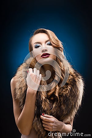 Portrait of beautiful elegant girl wearing a fur raccoon collar. Stock Photo