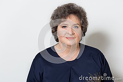 Portrait of beautiful elegant woman in a well-kept older srudii on a white background with makeup and without makeup Stock Photo