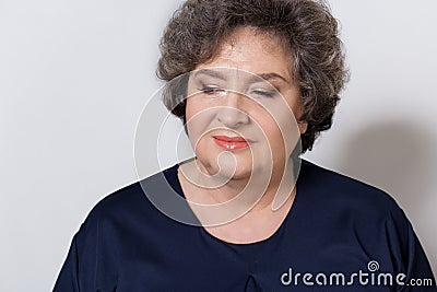 Portrait of beautiful elegant woman in a well-kept older srudii on a white background with makeup and without makeup Stock Photo