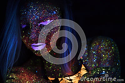 Portrait of Beautiful Fashion Woman in Neon UF Light. Model Girl with Fluorescent Creative Psychedelic MakeUp, Art Stock Photo