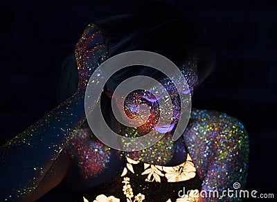 Portrait of Beautiful Fashion Woman in Neon UF Light. Model Girl with Fluorescent Creative Psychedelic MakeUp, Art Stock Photo