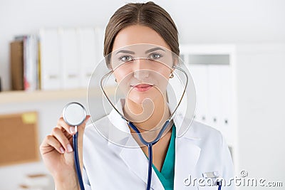 Portrait of beautiful female doctor holding stethoscope head Stock Photo