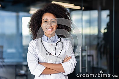 Portrait of beautiful female doctor inside office of modern clinic, female doctor smiling and looking at camera with Stock Photo