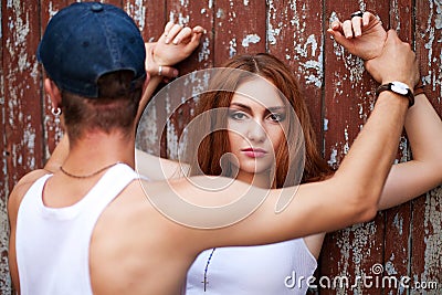 Portrait of a beautiful ginger girl standing with a man over woo Stock Photo