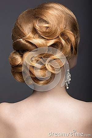 Portrait of a beautiful ginger woman in the image of the bride. Hairstyle back view Stock Photo