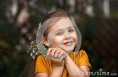 portrait of a beautiful girl with a bouquet of forget-me-nots Stock Photo